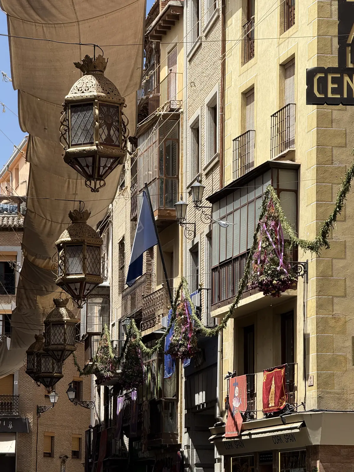 Calle del casco de Toledo cubierta de toldos con faroles y guirnaldas de flores en el Corpus — Foto propia La Maleta Inquieta, junio 2026