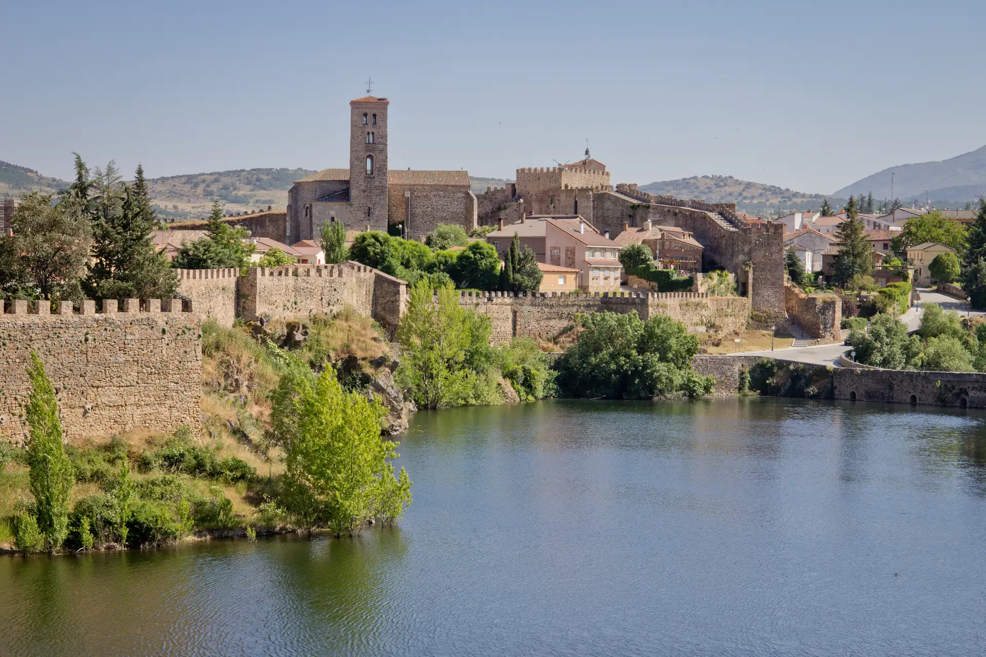 Torre y lienzo de la muralla de Buitrago del Lozoya con el casco medieval al fondo.