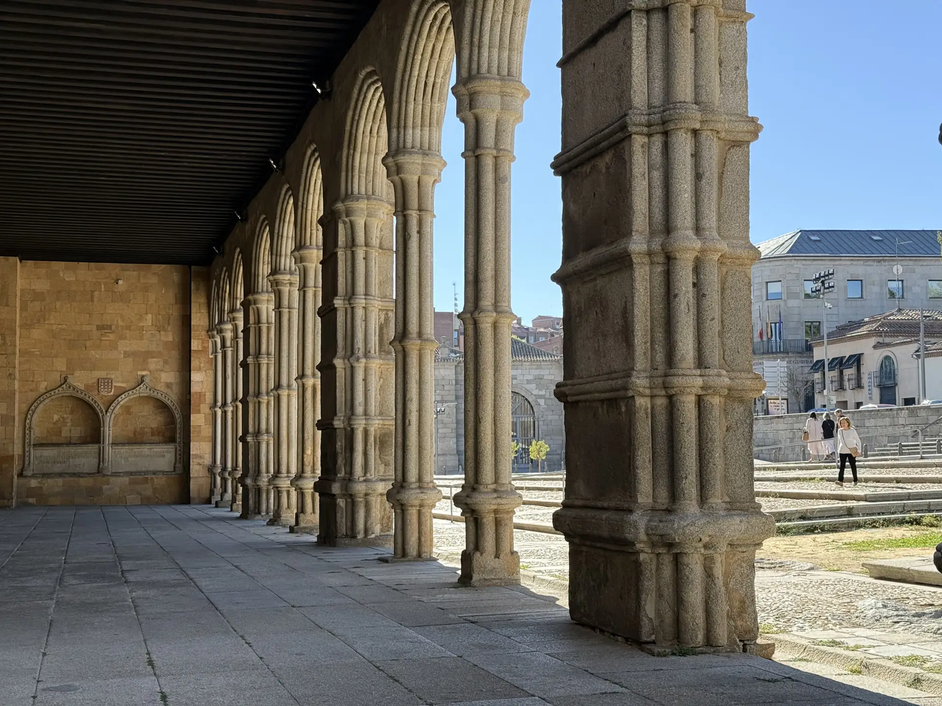 Galería del pórtico sur de San Vicente de Ávila con techumbre de madera y el sepulcro de arcosolios al fondo. Foto propia La Maleta Inquieta, septiembre 2026.