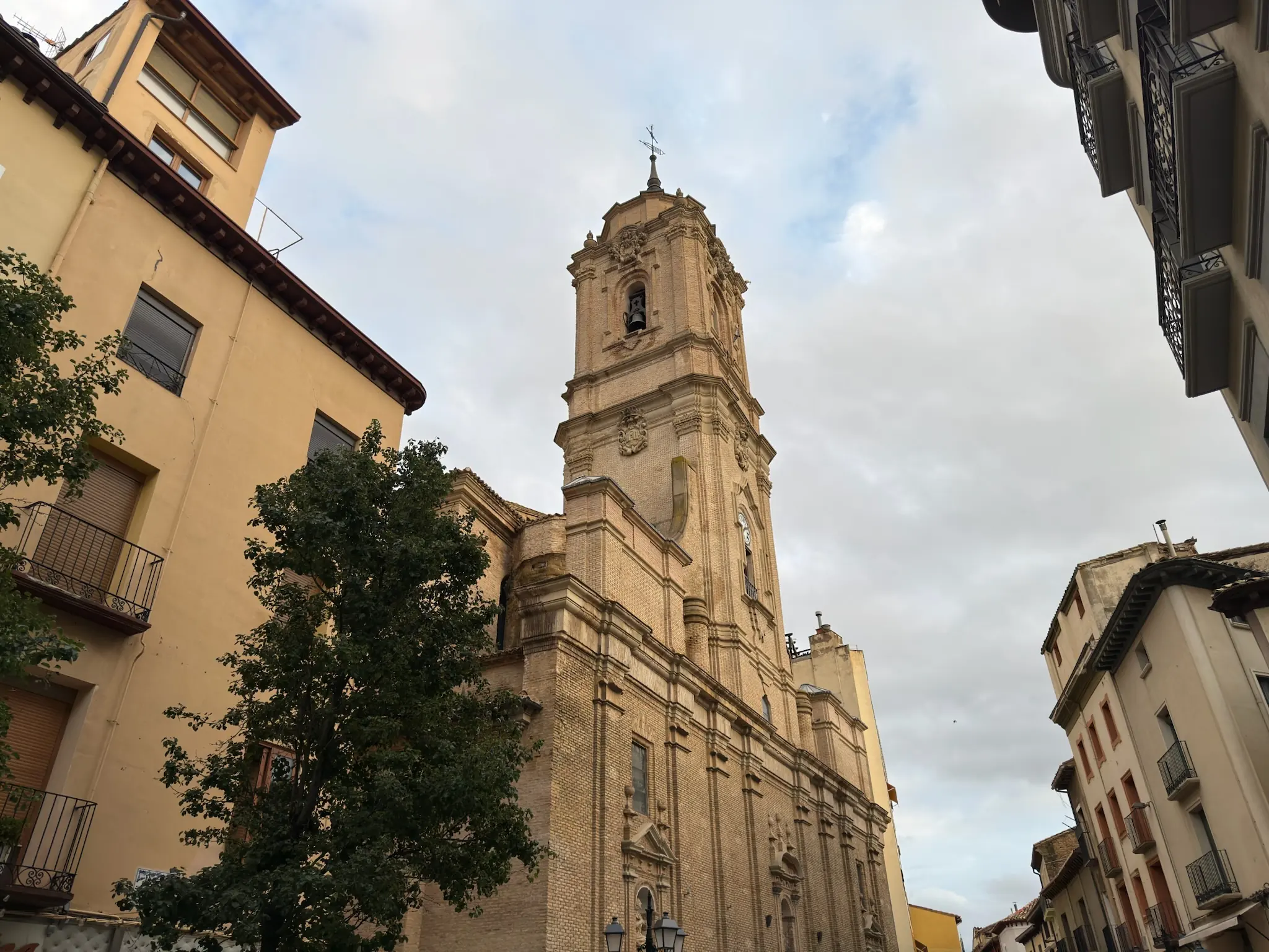 Torre barroca y fachada de ladrillo de la basílica de San Lorenzo, entre las casas del casco de Huesca. Foto propia La Maleta Inquieta, octubre 2026