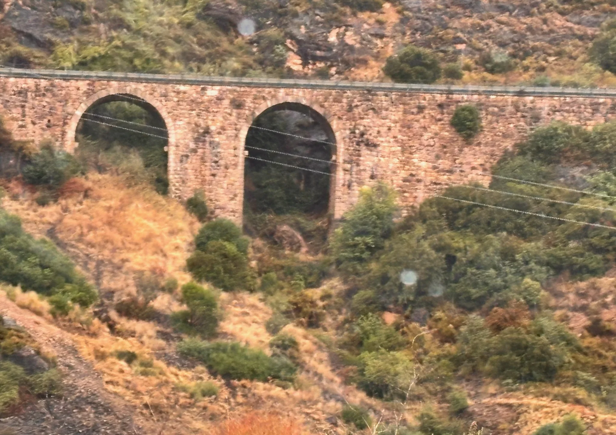 Viaducto antiguo de piedra con dos arcos de medio punto sobre barranco con vegetación mediterránea cerca de Agüero. Foto propia La Maleta Inquieta, octubre 2026